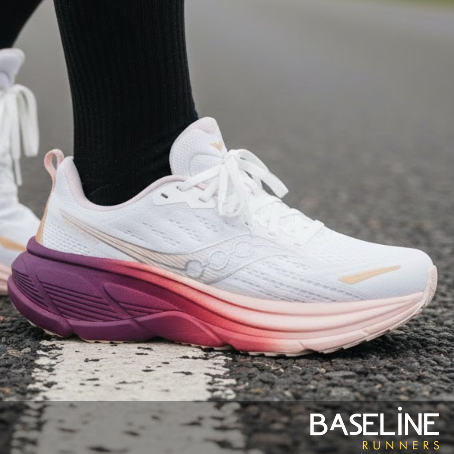White running shoe with purple and pink gradient sole on a road, featuring 'Baseline Runners' branding.