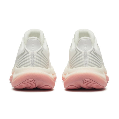 Back view of white Saucony running shoes with pink soles on a white background