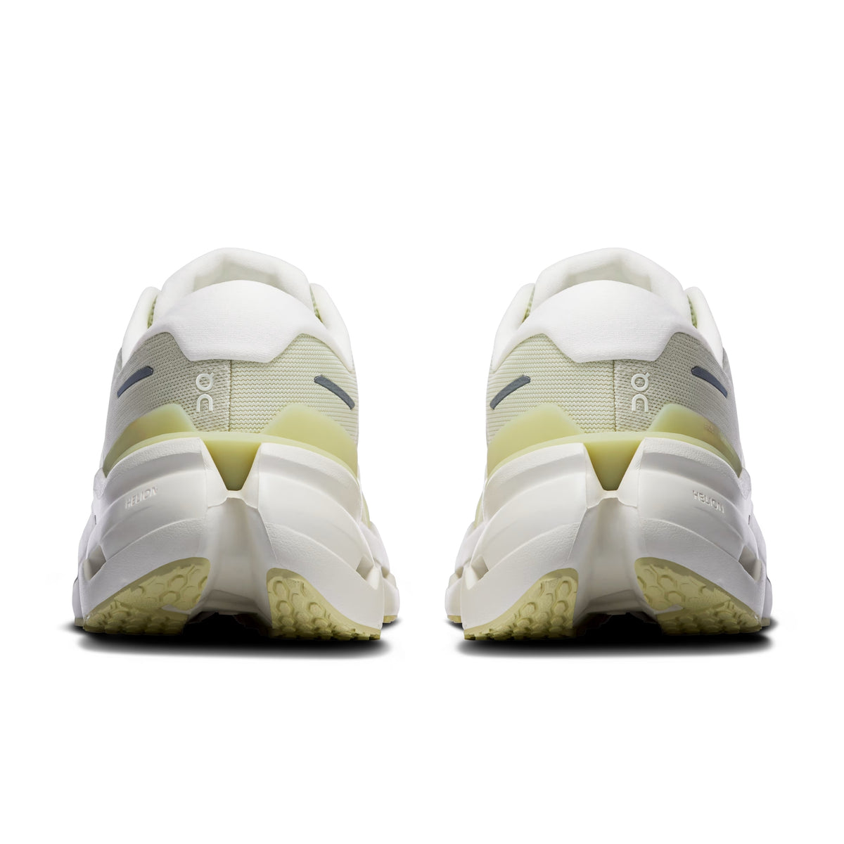 A pair of white and pale yellow-green On running shoe shown from the back, featuring a chunky sole and the 'on' logo on the sides, set against a plain white background.