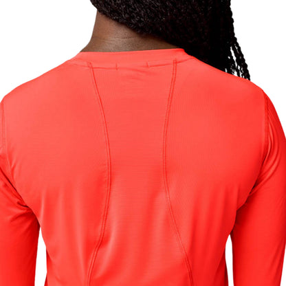 Woman wearing a orange long sleeve shirt on a white background