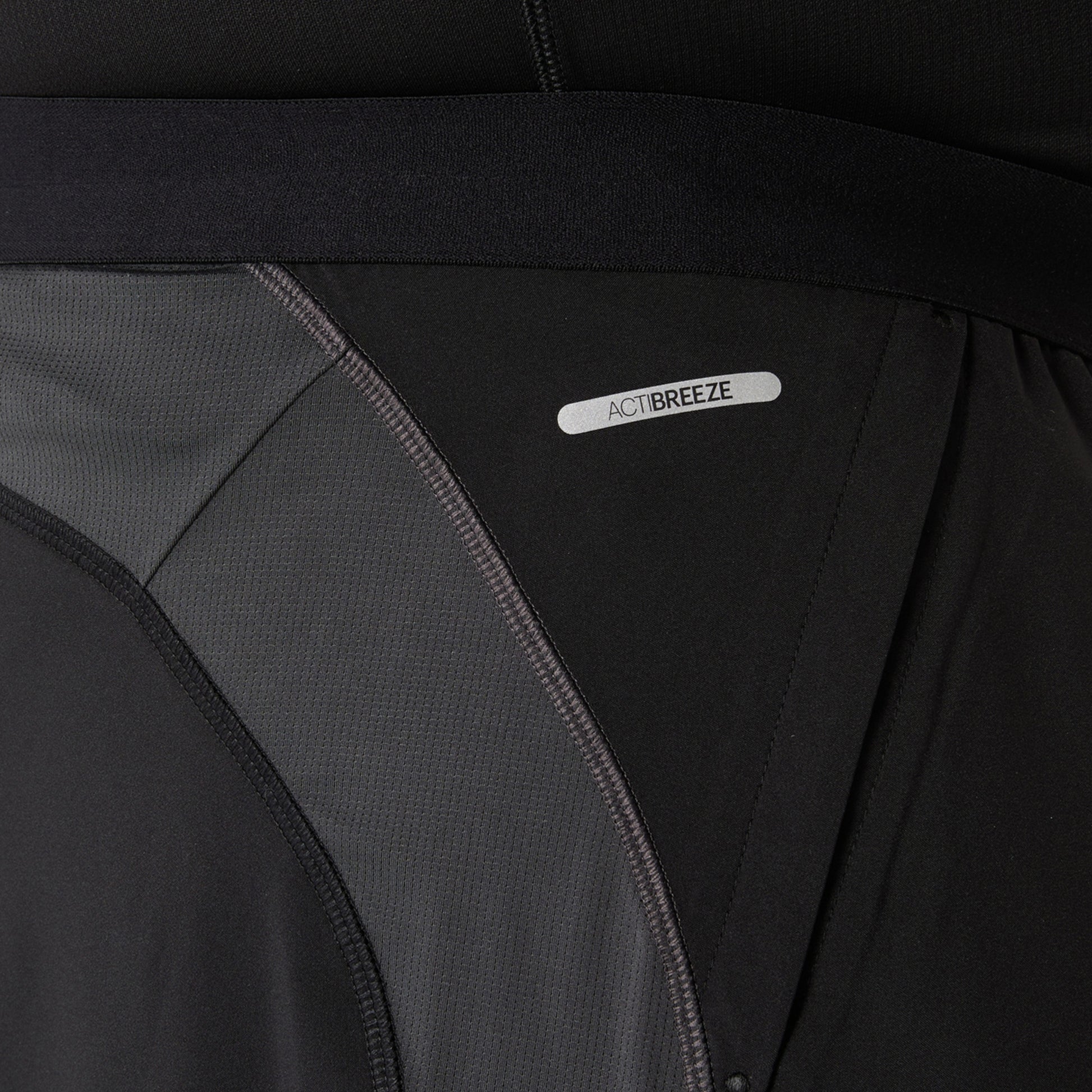 Close-up of a black and gray Asics shorts with 'ActiBreeze' label