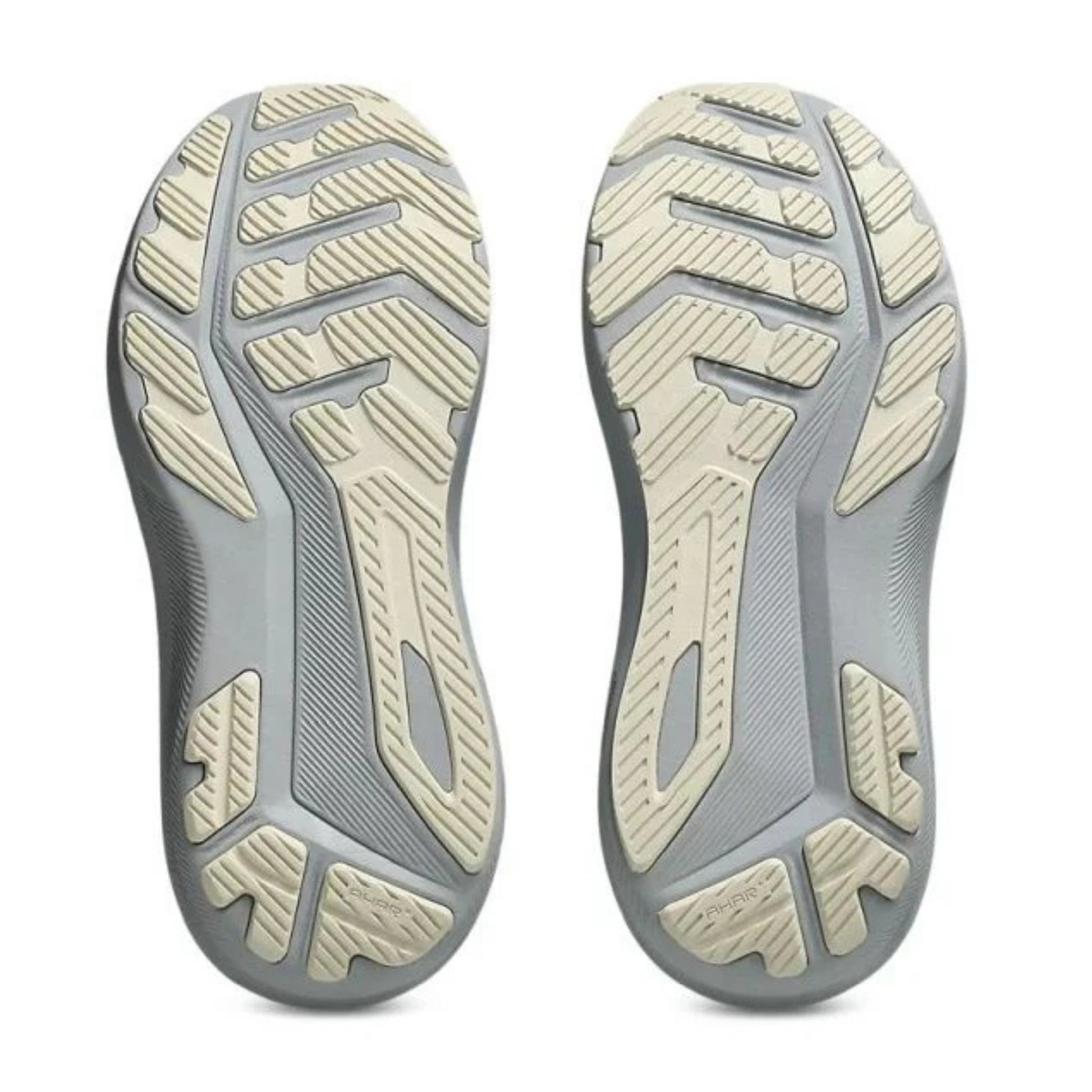 Close-up of a pair of gray and beige shoe soles on a white background