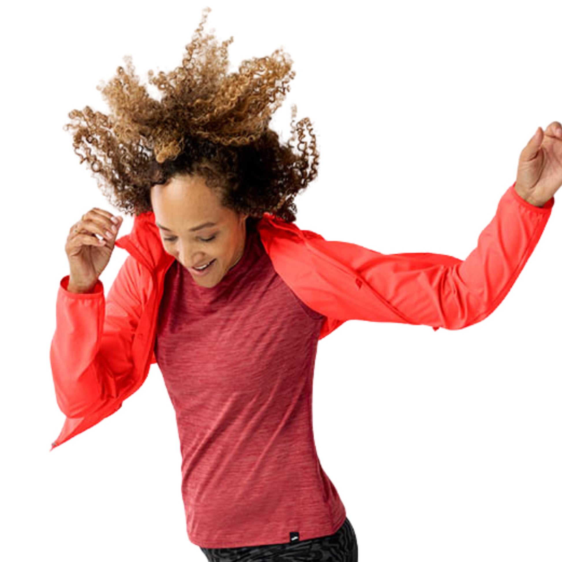 Woman wearing a orange jacket with a Brooks logo on a white background