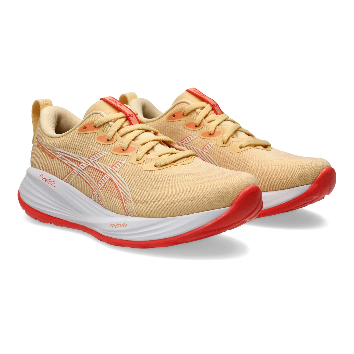 Light orange running shoes with red soles on a white background