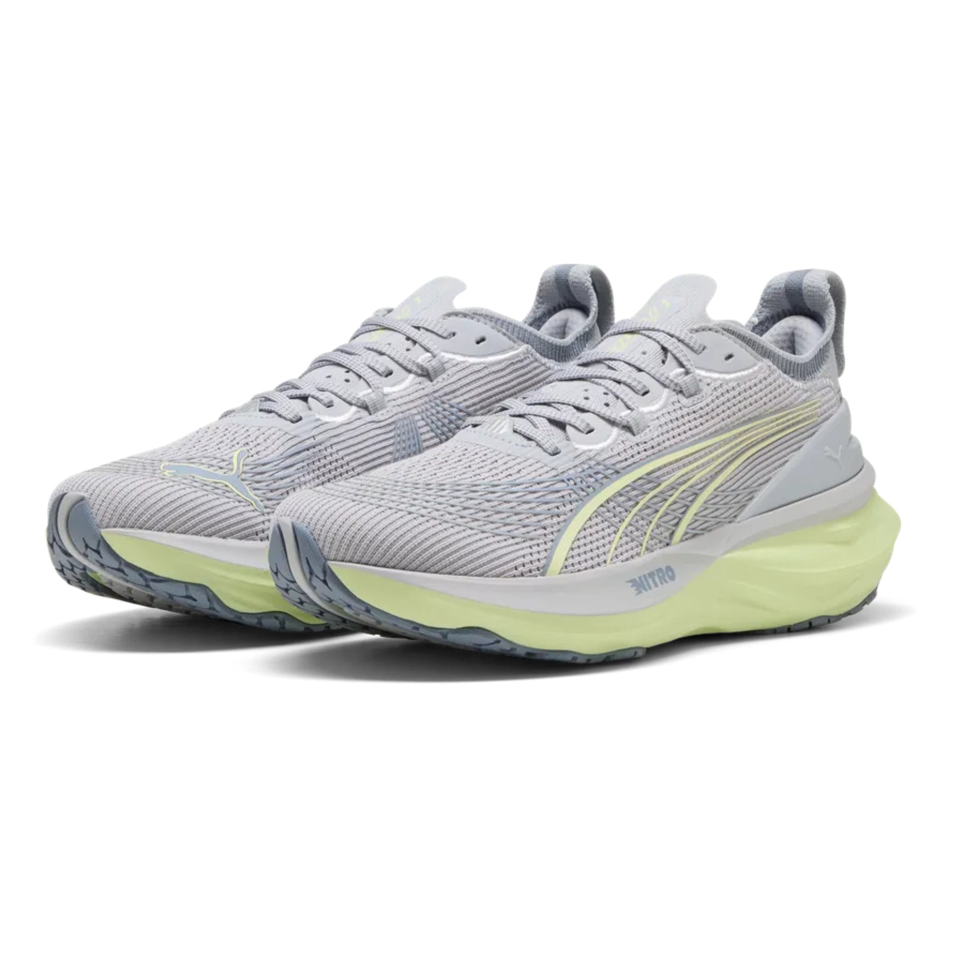 Pair of gray Puma running shoes with yellow accents on a white background