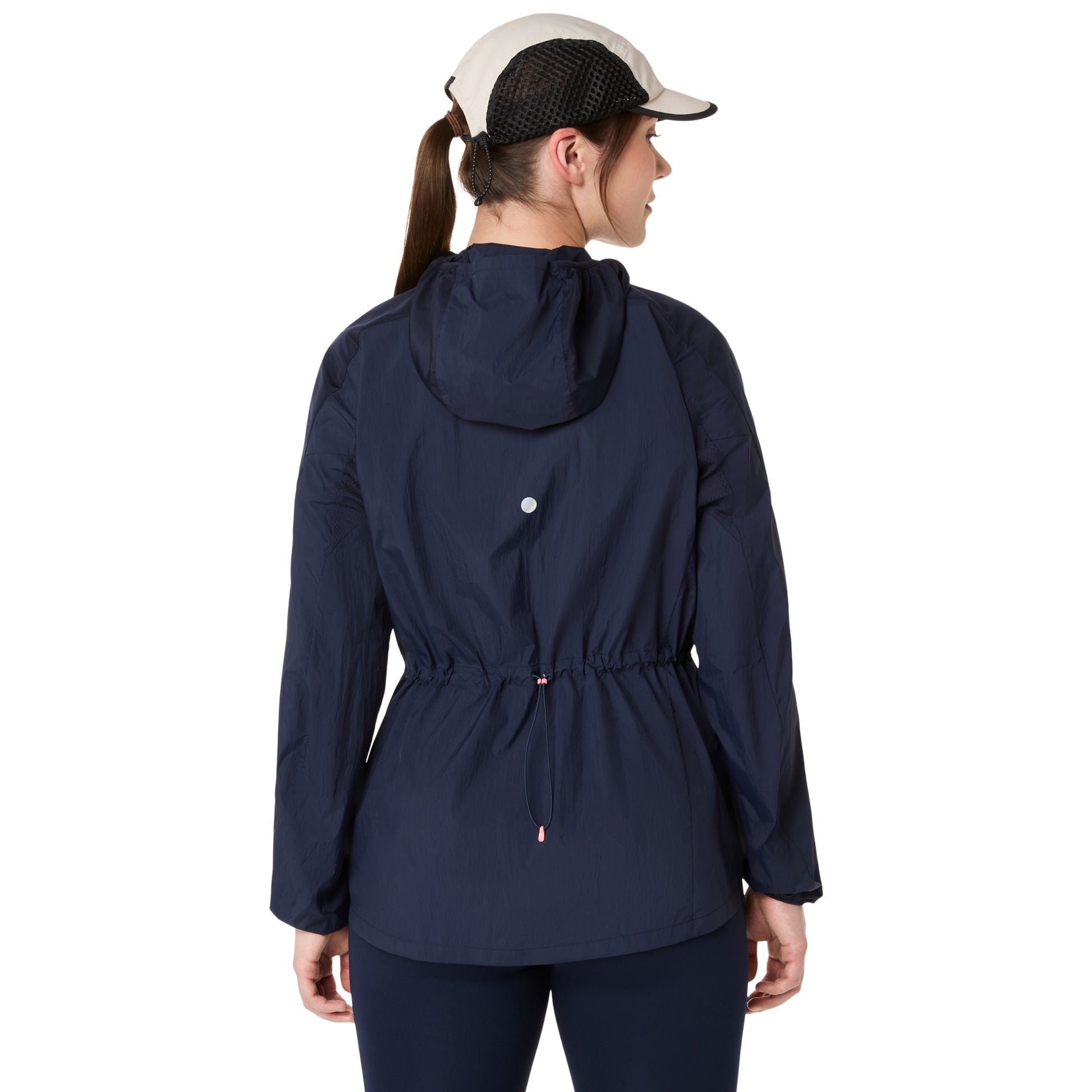 Person wearing a navy blue jacket with a white cap on a white background