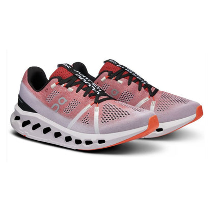 Pink and black running shoes with white sole on a white background