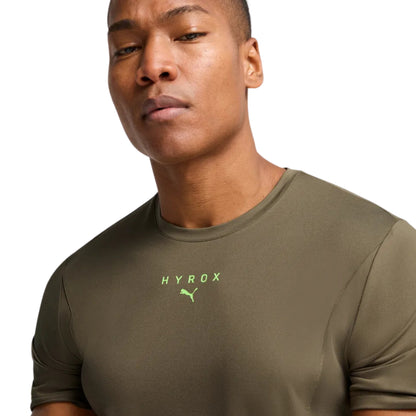 Man wearing a green athletic shirt with 'HYROX' logo on a white background