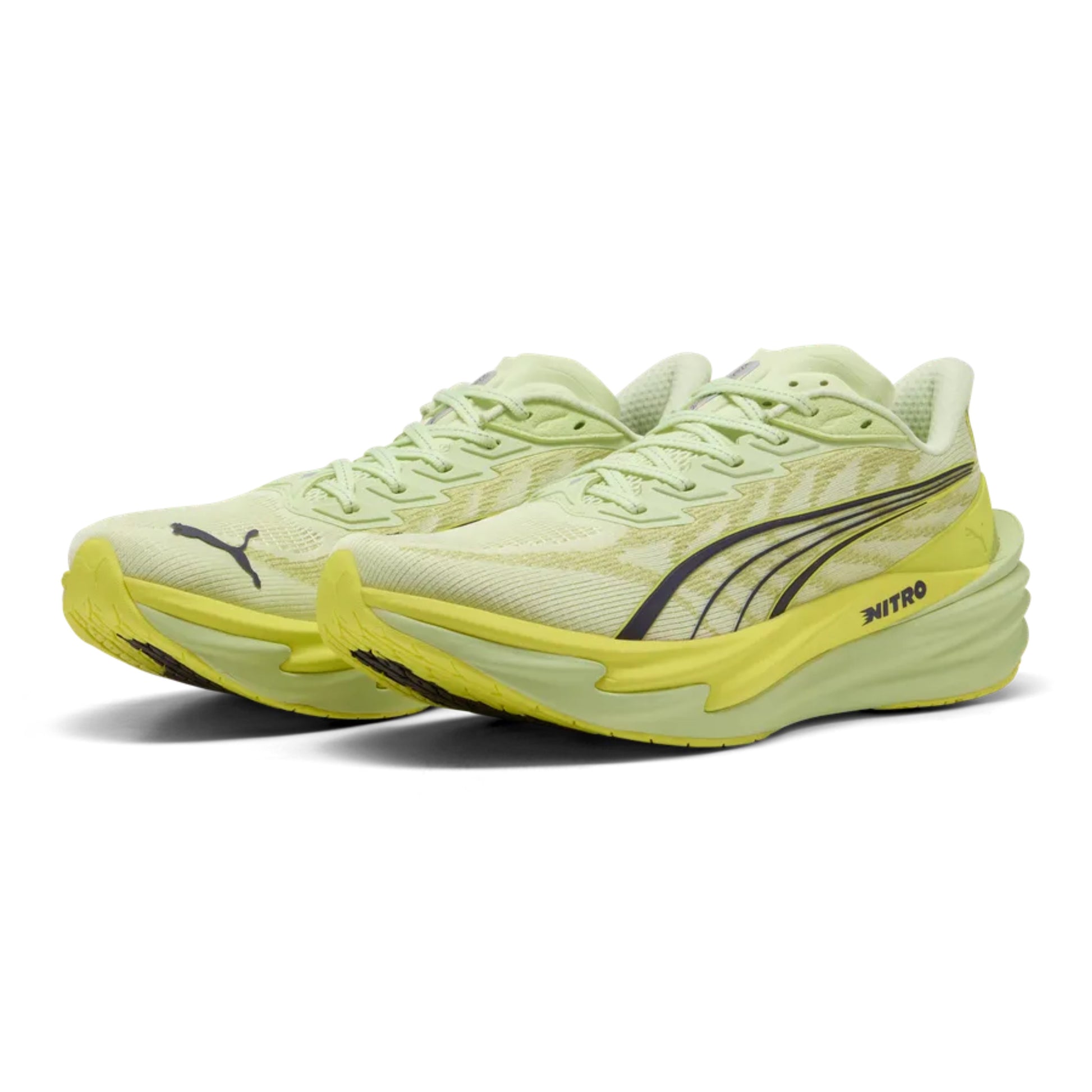 Pair of yellow Puma running shoes with yellow soles on a white background