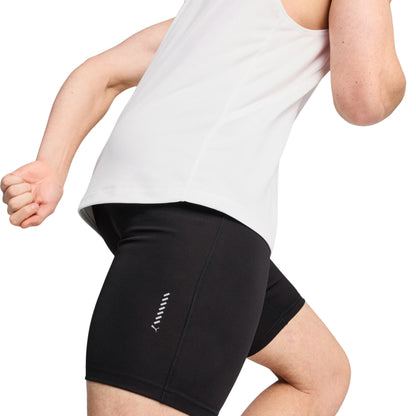 Person wearing black Puma tights with a brand logo on a white background