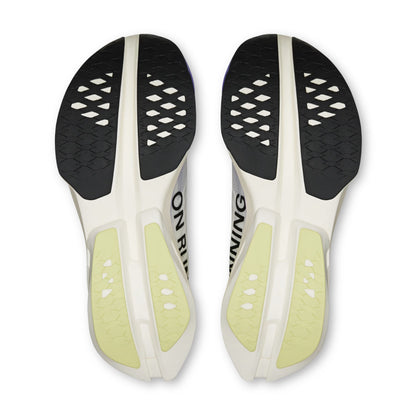 Top-down view of a pair of On running shoe soles, showing a white and black tread pattern with pale yellow-green cushioning areas and the partial text 'ON RUNNING".