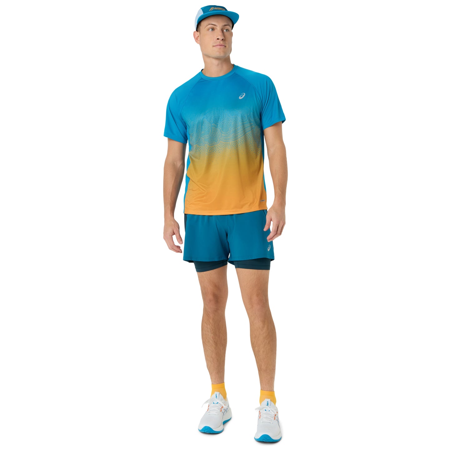 Person wearing blue and yellow Asics running shirt on a white background