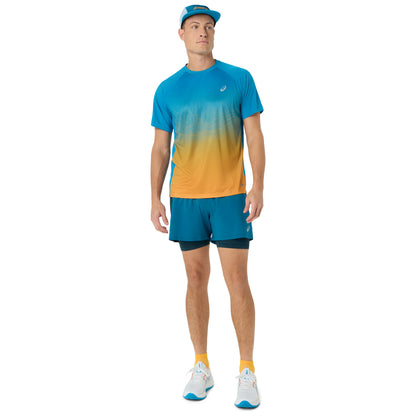Person wearing blue and yellow Asics running shirt on a white background