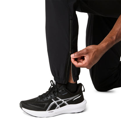 Person wearing black athletic shoes with a white logo on a white background