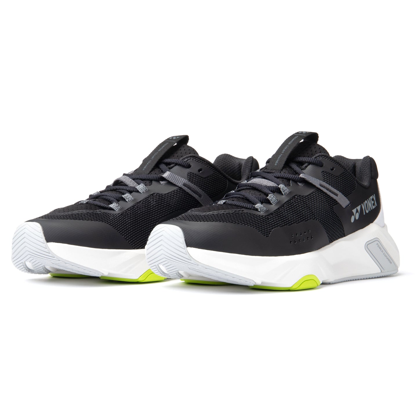 Black and white Yonex running shoes with green accents on a white background