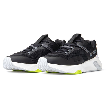 Black and white Yonex running shoes with green accents on a white background