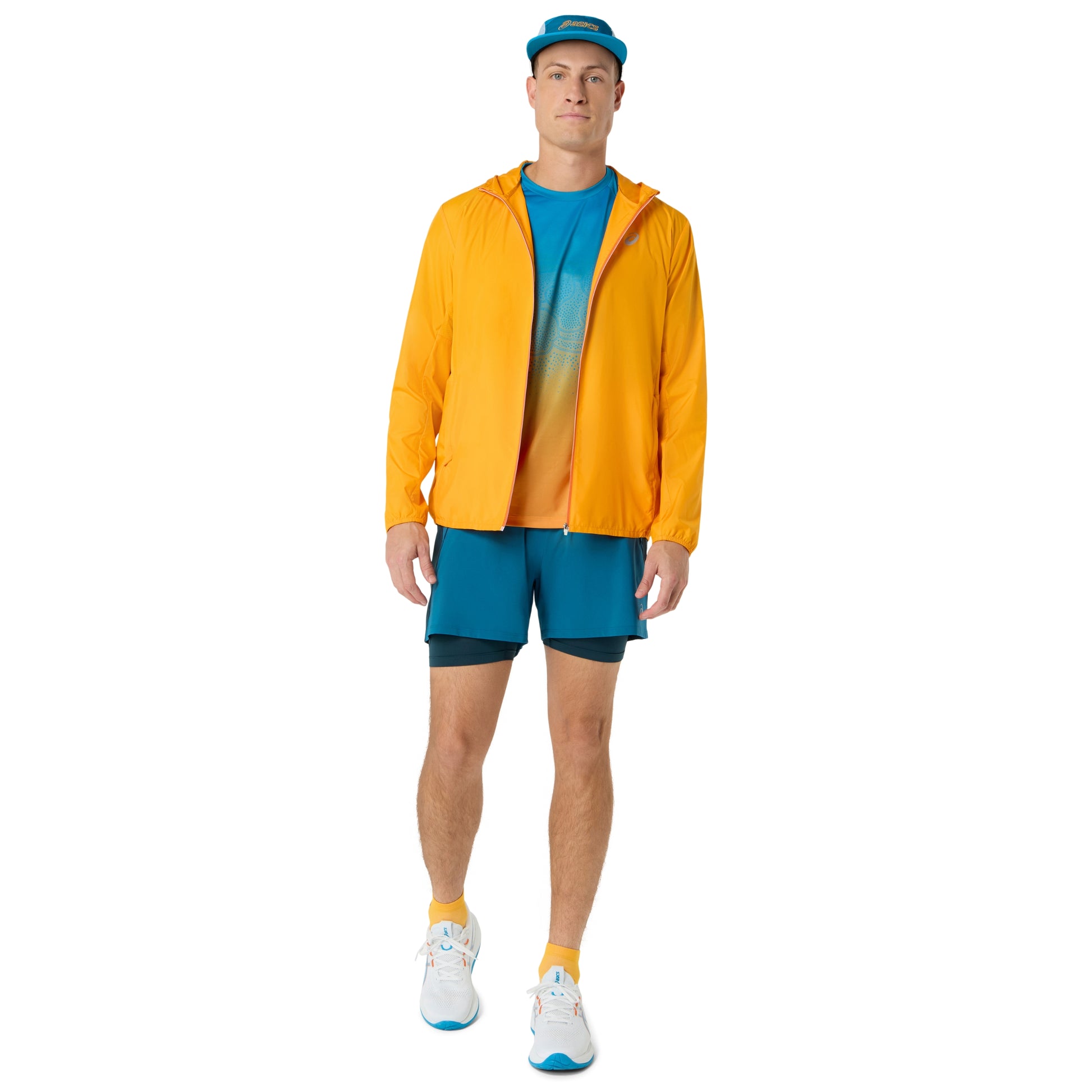 Person wearing blue and yellow Asics running shirt on a white background