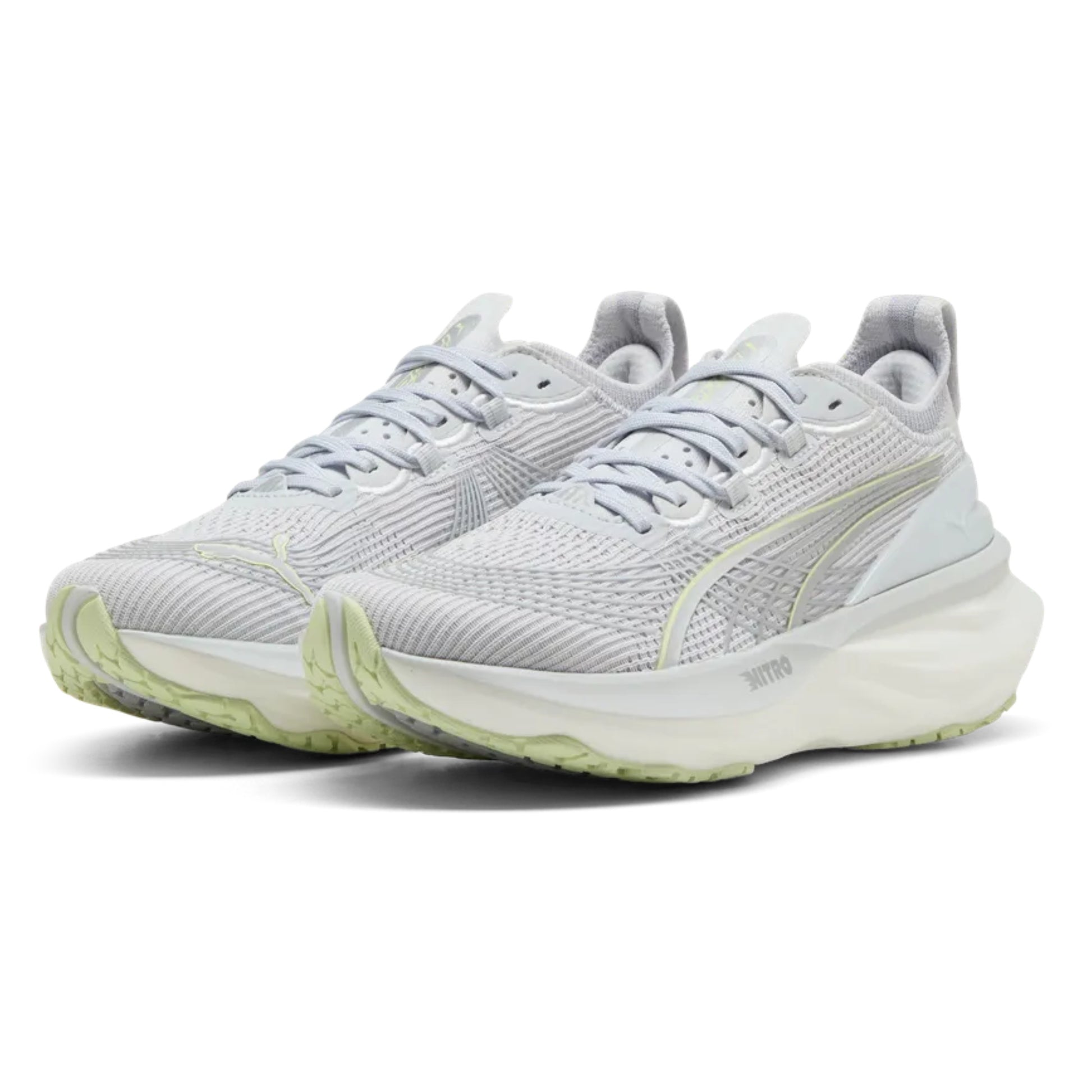 Pair of light gray Puma running shoes with green accents on a white background
