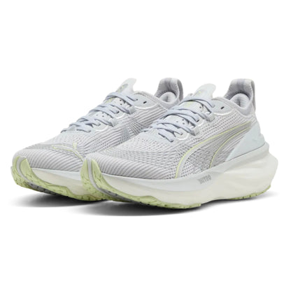 Pair of light gray Puma running shoes with green accents on a white background