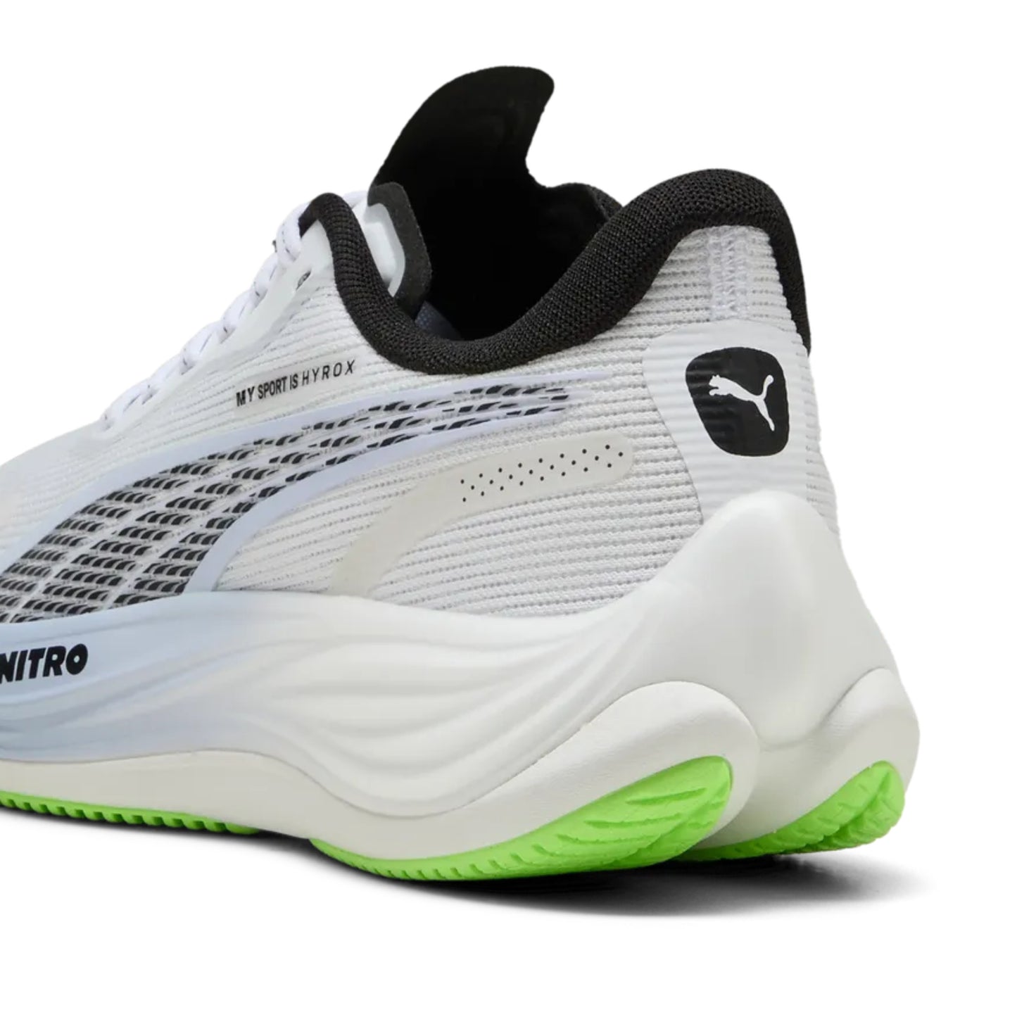 White Puma running shoe with black and green accents on a white background