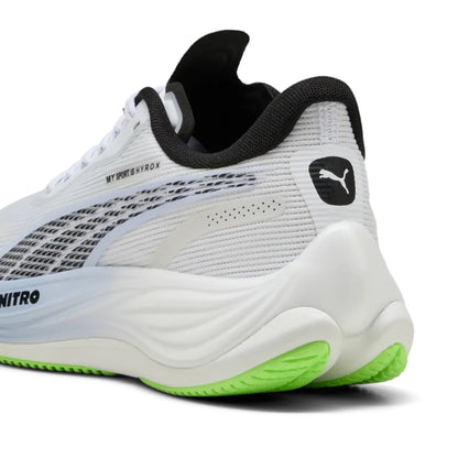 White Puma running shoe with black and green accents on a white background