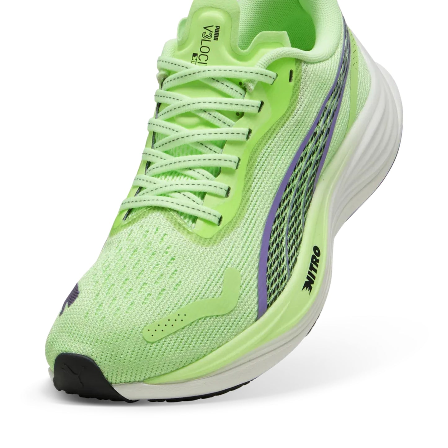 Green Puma running shoe with white sole on a white background