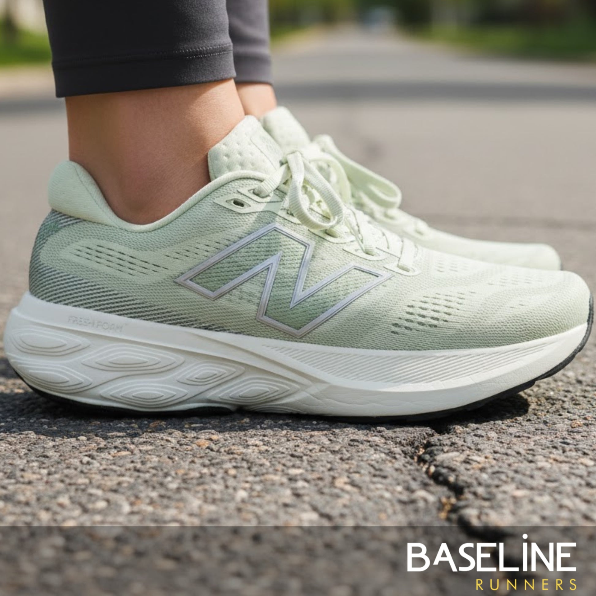 Light green running shoe with New Balance logo on a road, featuring 'Baseline Runners' branding.