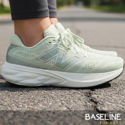 Light green running shoe with New Balance logo on a road, featuring 'Baseline Runners' branding.