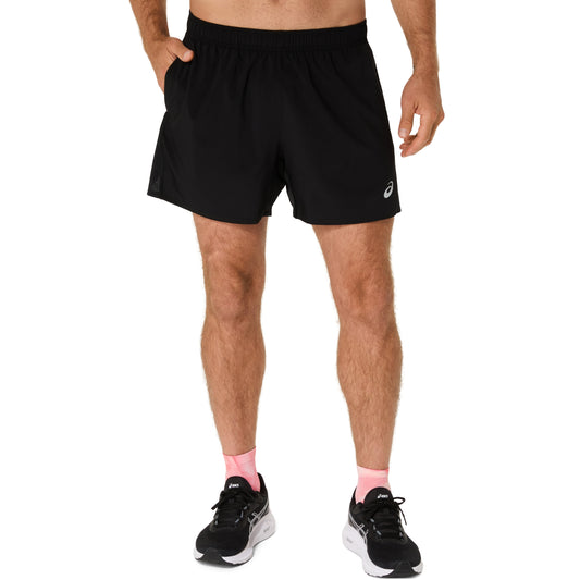 Person wearing black athletic shorts with a brand logo on a white background