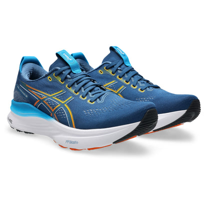 Blue running shoes with white soles on a white background