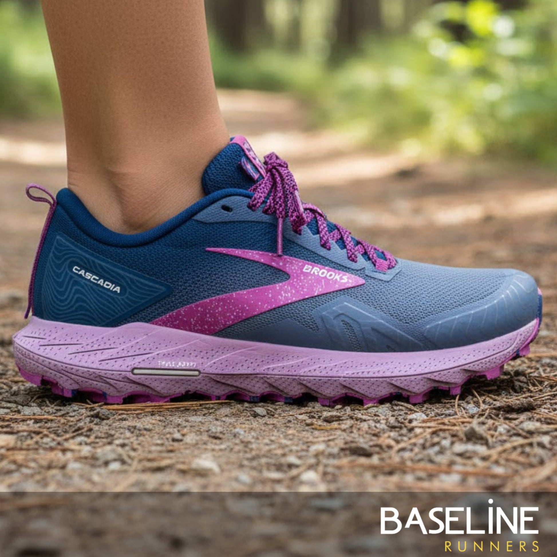 Blue and purple running shoe on a natural path with 'Baseline Runners' branding.