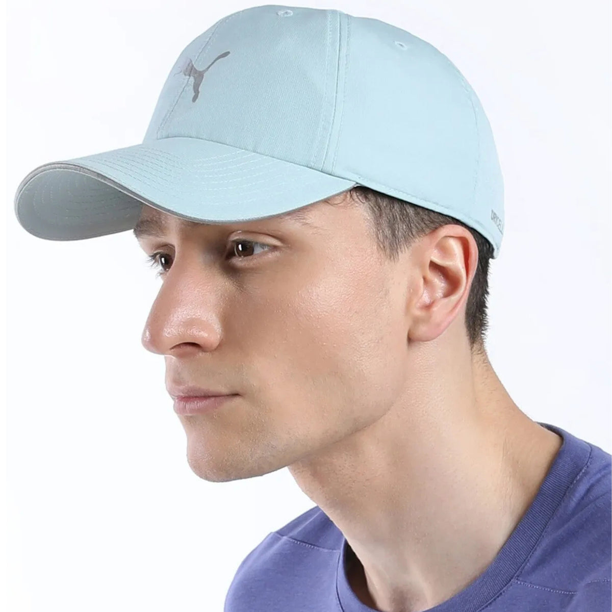 Person wearing a light blue Puma cap with a silver logo on a white background