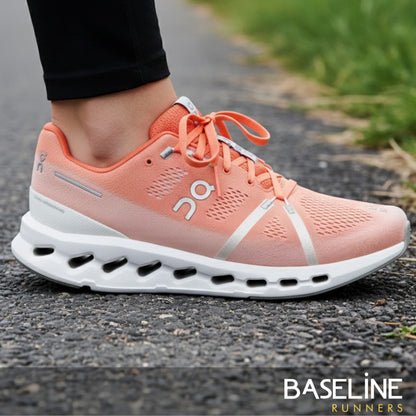White/Flame running shoe with logo on the side with someone wearing the shoe on a road 