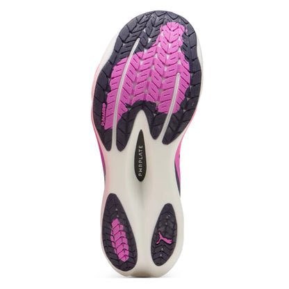 Close-up of a Puma running shoe sole with pink and black design on a white background
