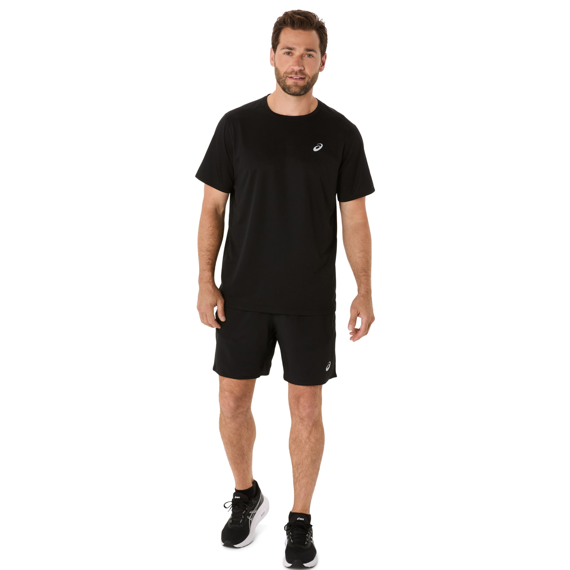 Man wearing a black t-shirt and running shorts with a visible brand logo on a white background