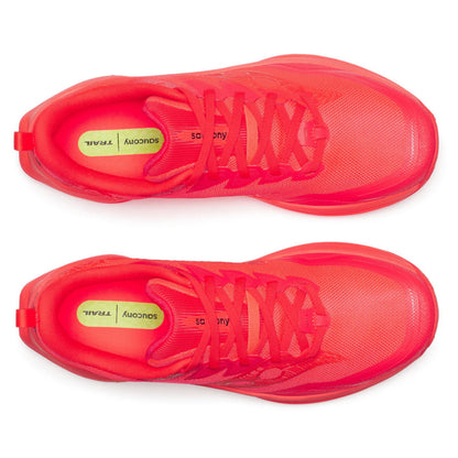 Pair of red Saucony running shoes on a white background