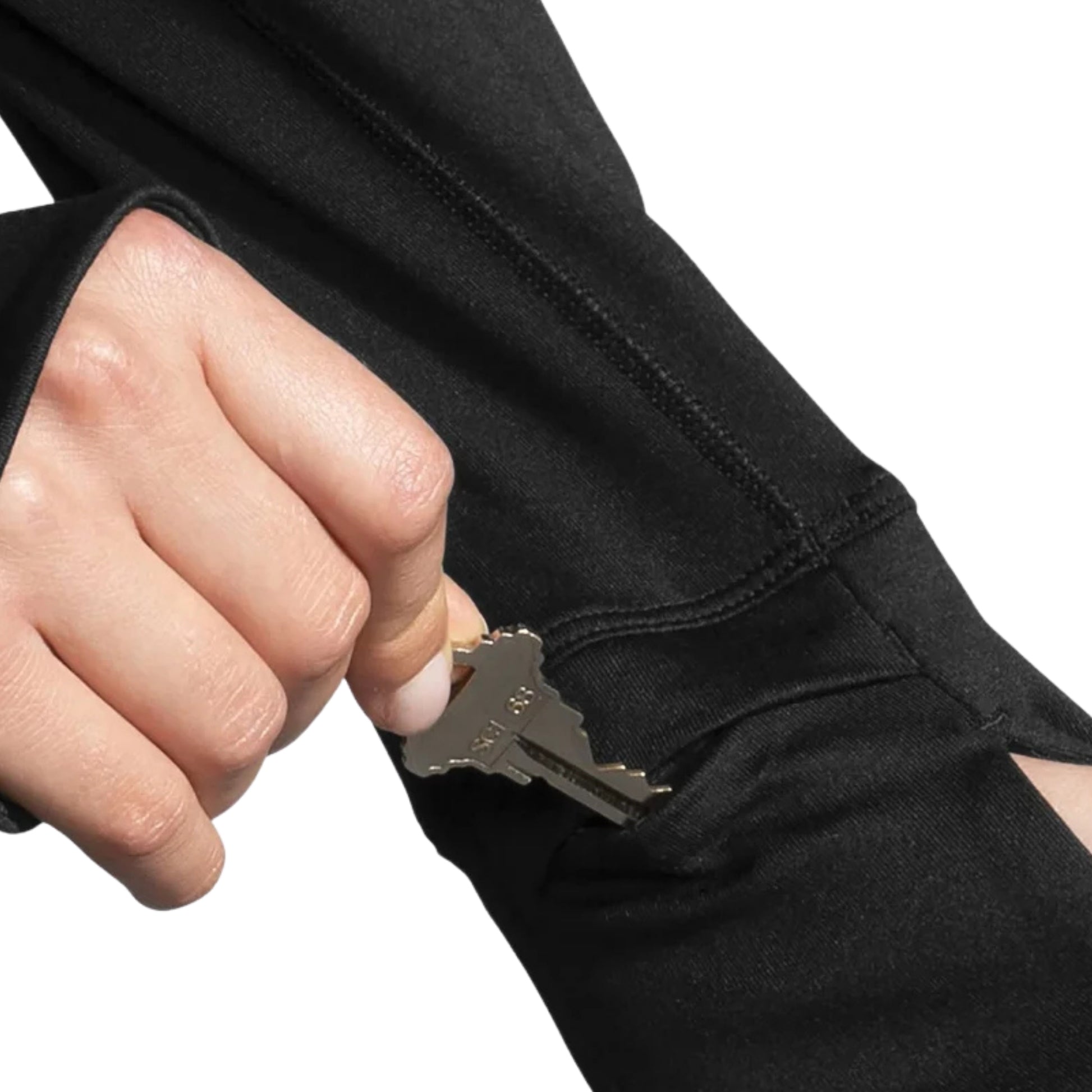Close-up of a woman putting a key inside a long sleeve shirt on a white background
