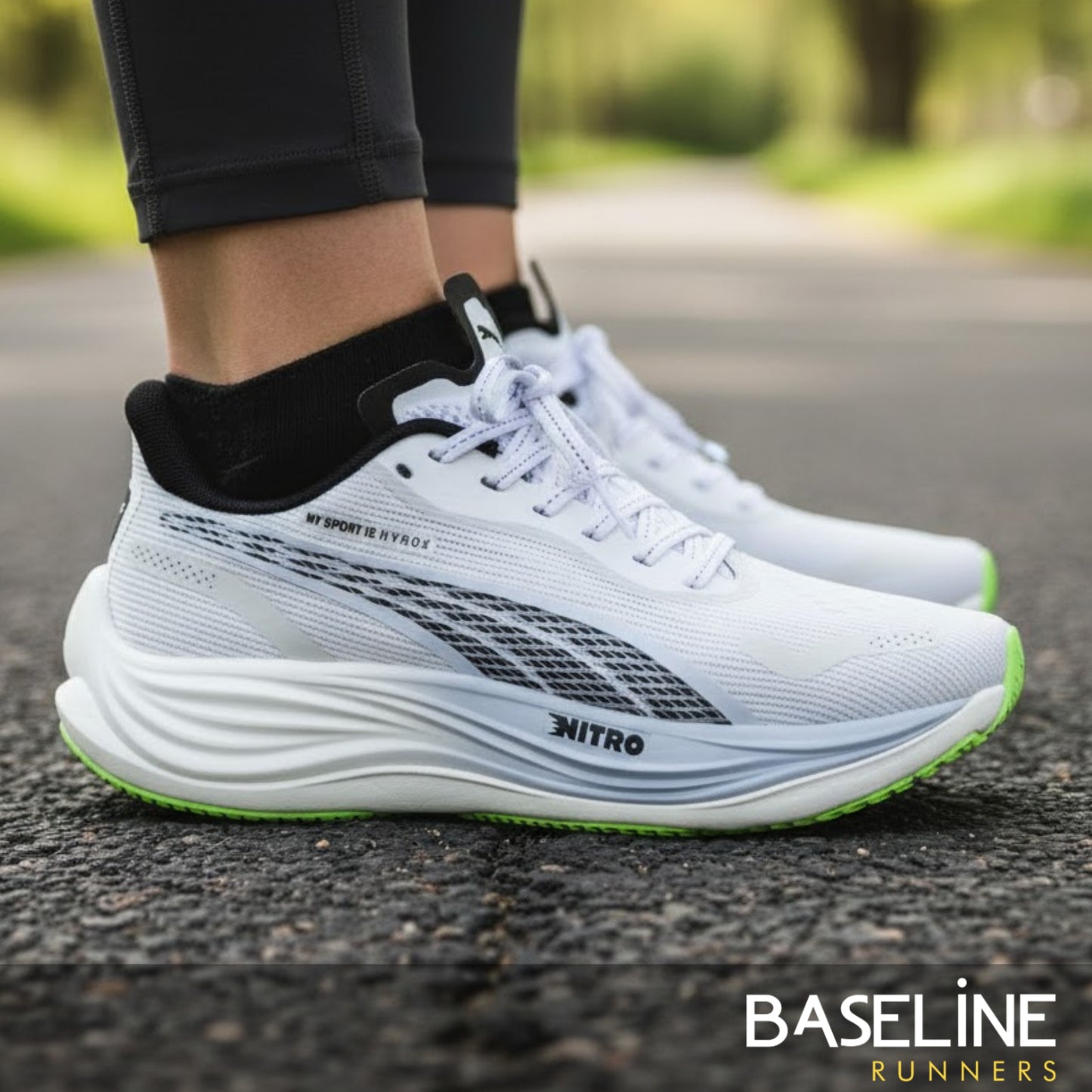 White Puma running shoes with green sole on a road, featuring the brand 'Baseline Runners'.