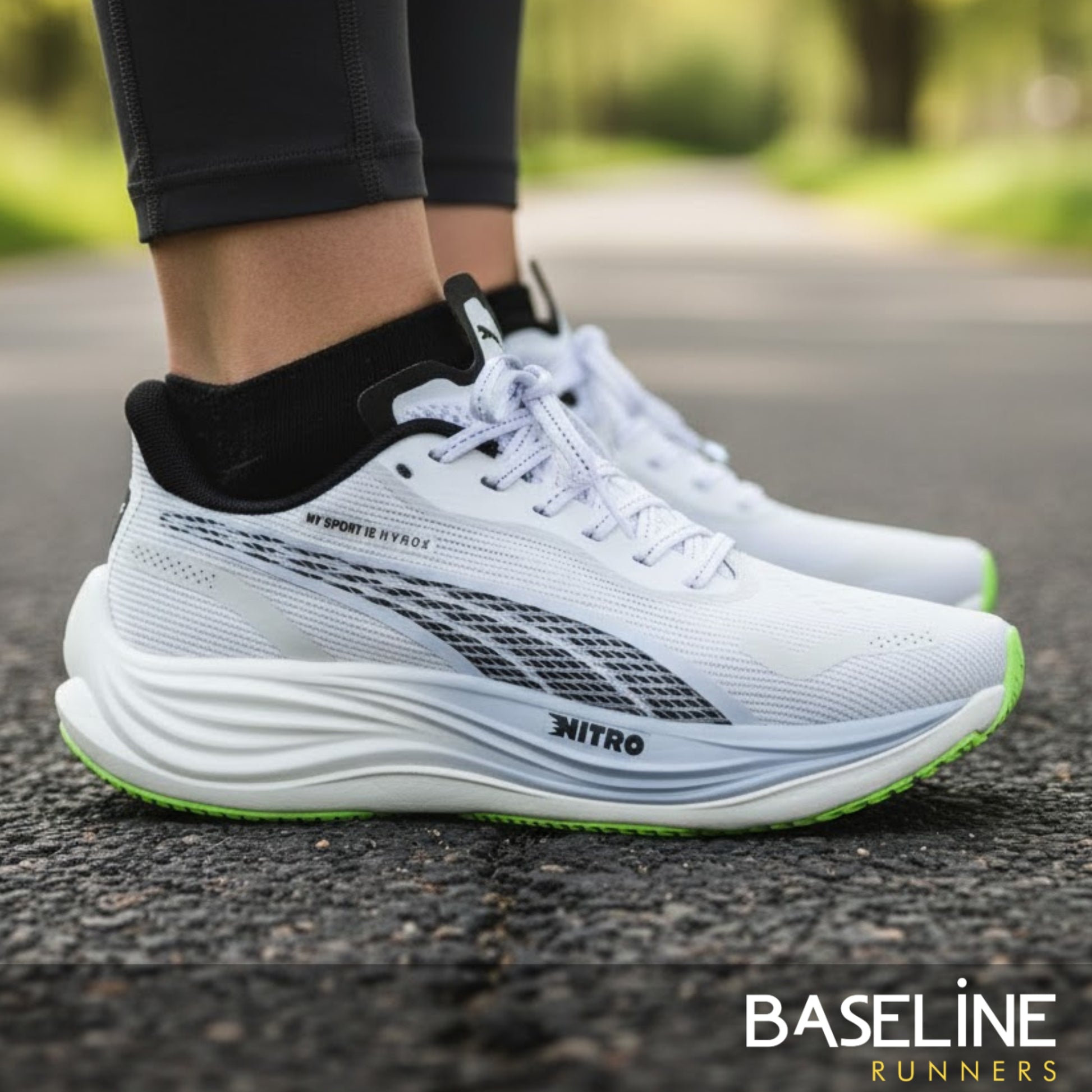 White Puma running shoes with green sole on a road, featuring the brand 'Baseline Runners'.