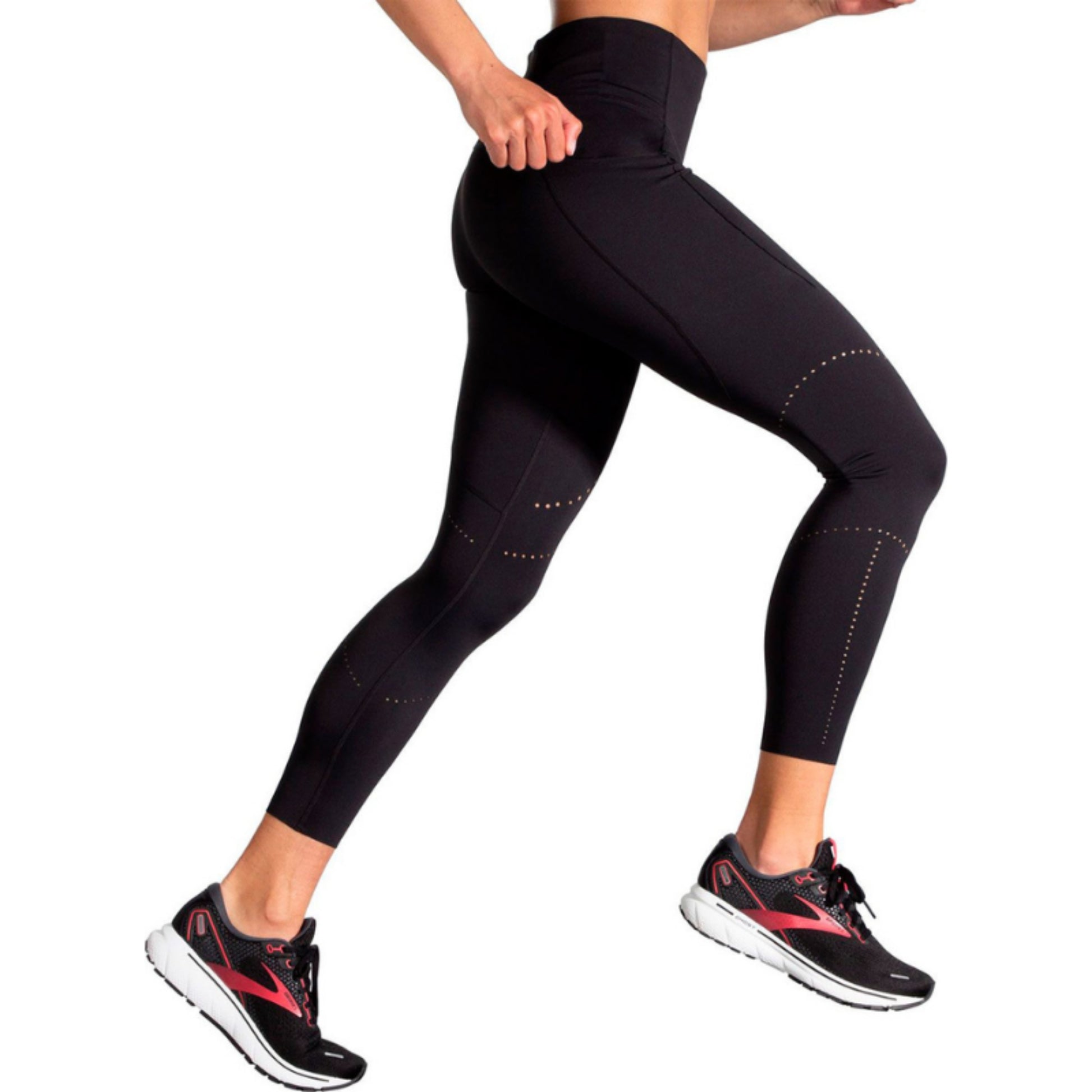 Woman wearing a black Brooks legings on a white background