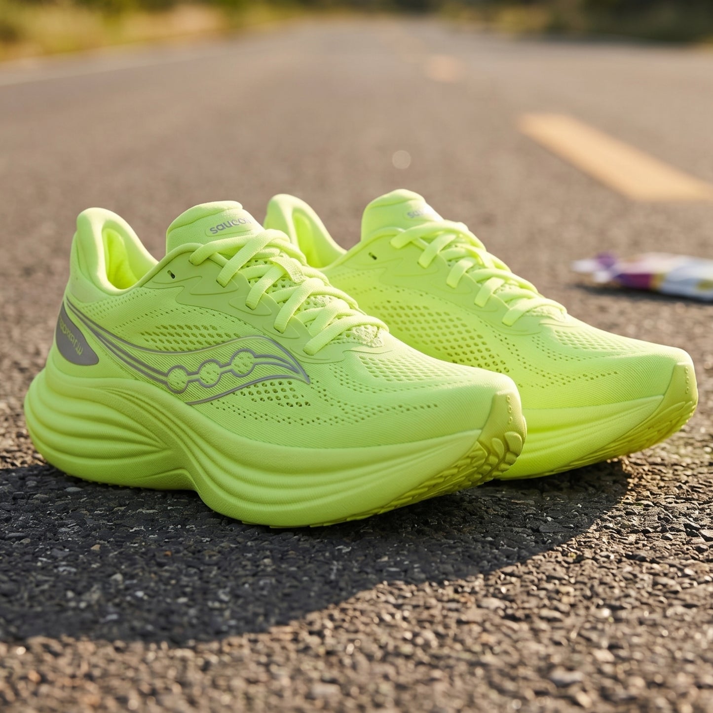 Neon green Saucony running shoes on a road