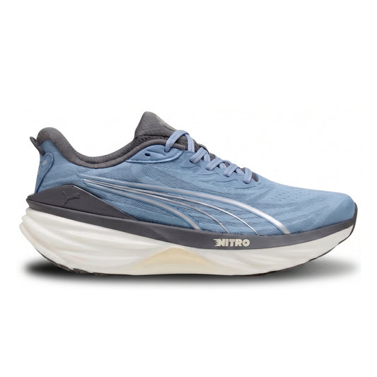 A Puma running shoe in light blue with a thick white and dark gray sole, featuring the Puma cat logo and 'NITRO' branding on the side.