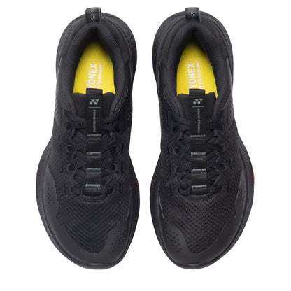 Black Yonex running shoes with yellow accents on a white background