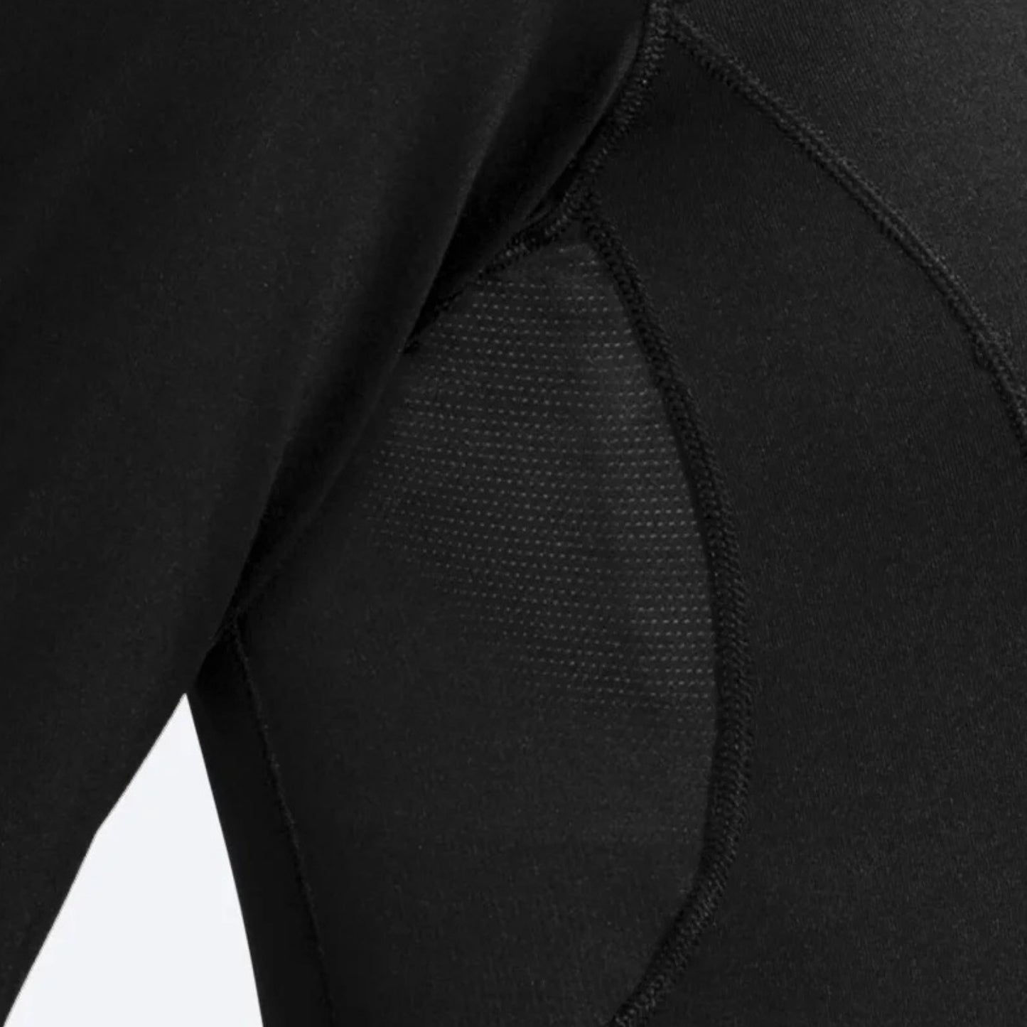 Close-up of a woman wearing a black long sleve shirt focusing on the details of the shirt