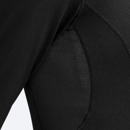 Close-up of a woman wearing a black long sleve shirt focusing on the details of the shirt