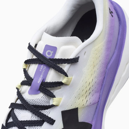 A close-up of a white On running shoe with purple and cream gradient accents, black laces, and a purple tongue tag reading 'COURTSPORTS MAX'.