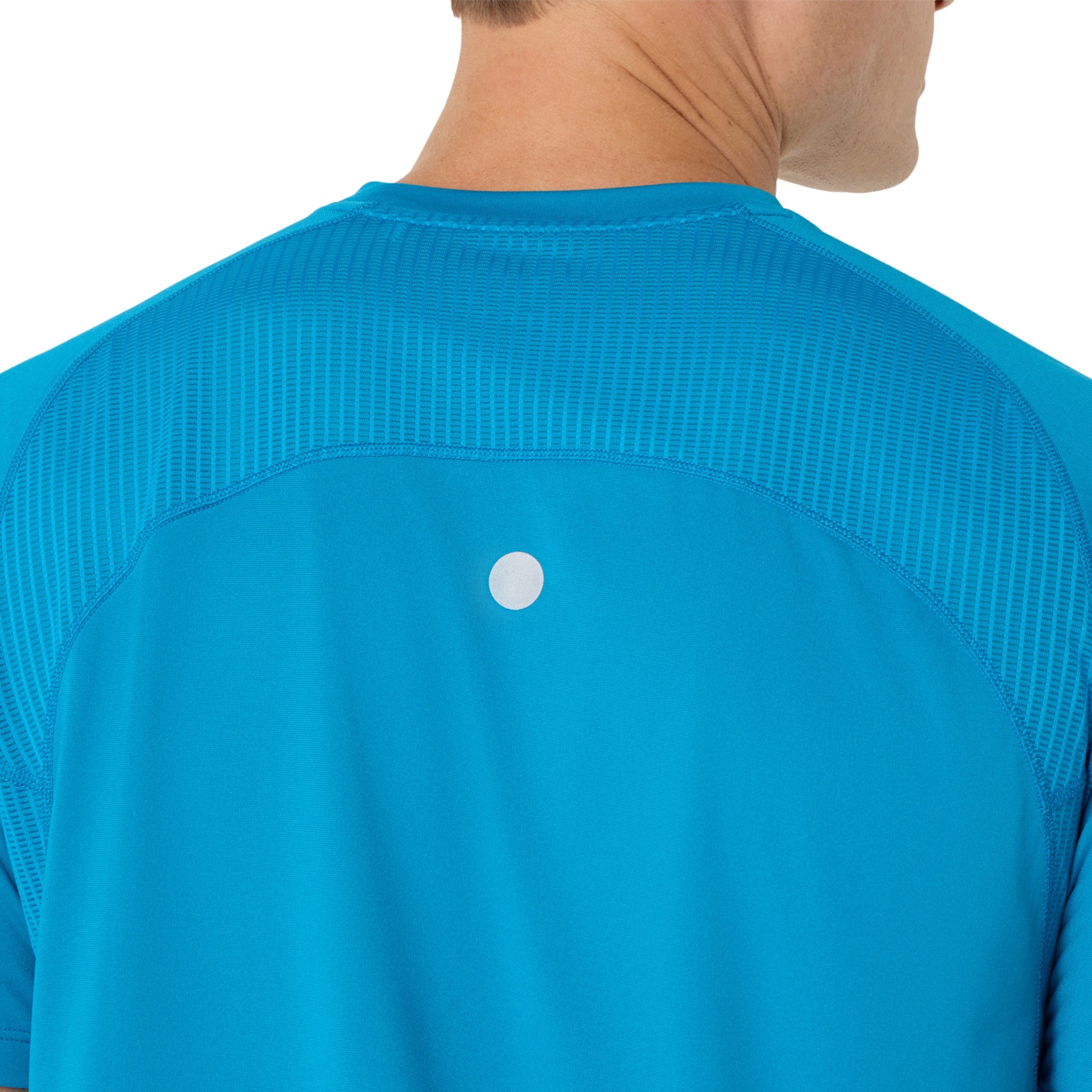 Close-up of a blue Asics running shirt with a silver dot on a white background