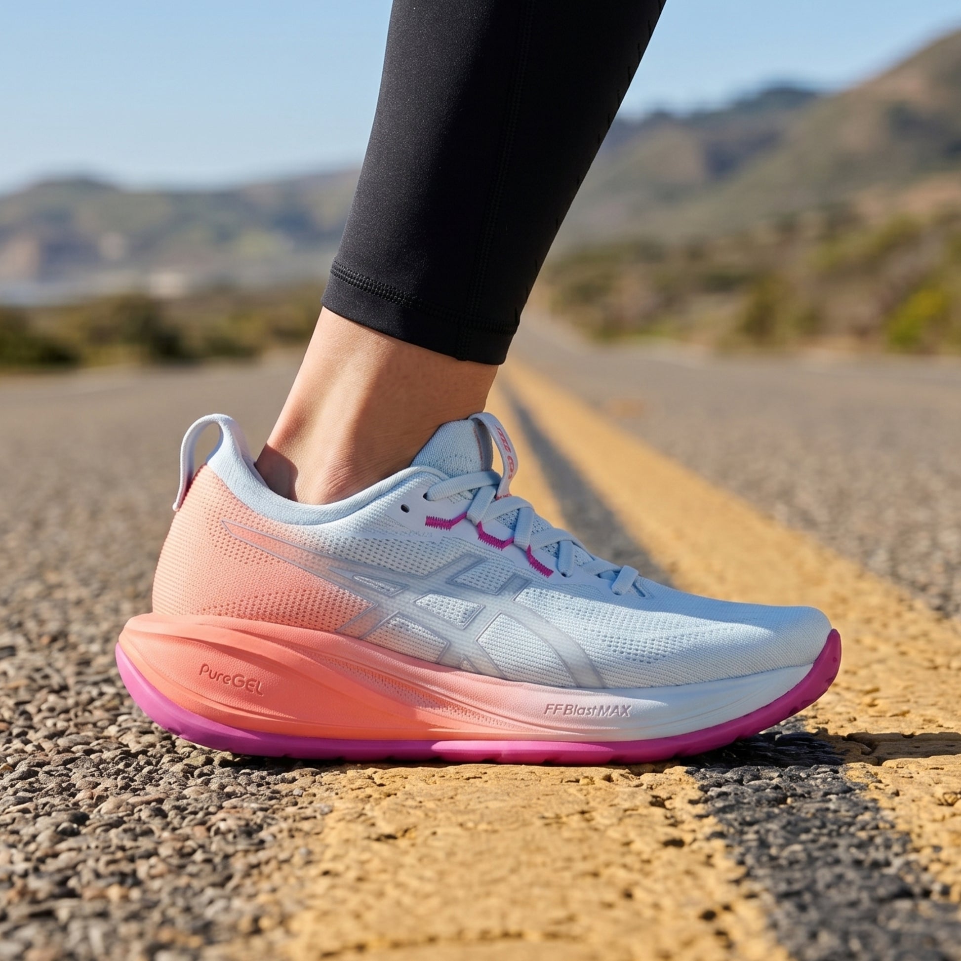 Person wearing light blue Asics runing shoe on a road background