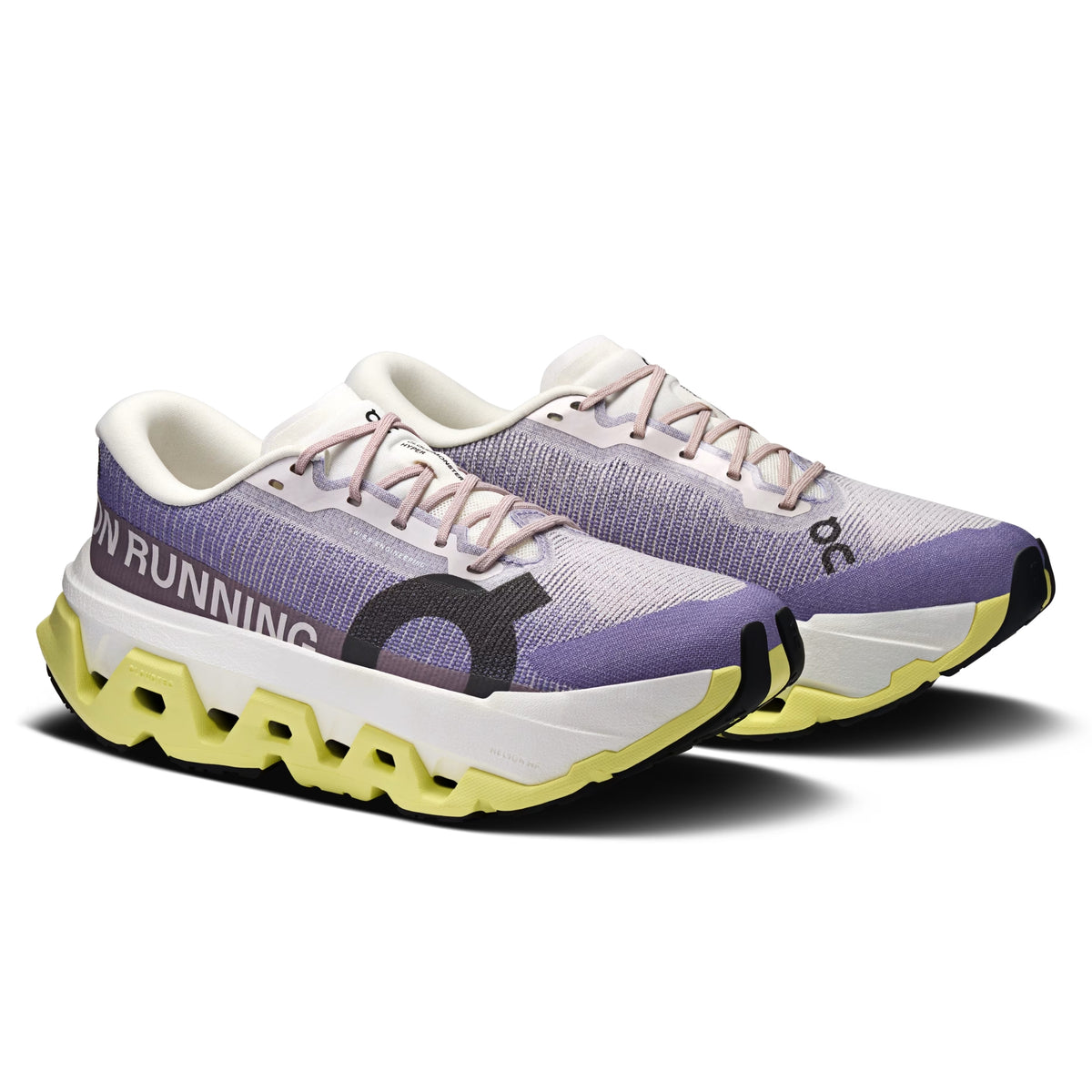 A pair of On running shoes in a lavender purple and white knit upper, featuring a chunky white midsole with a bright yellow-green sculpted outsole and a black logo on the side.