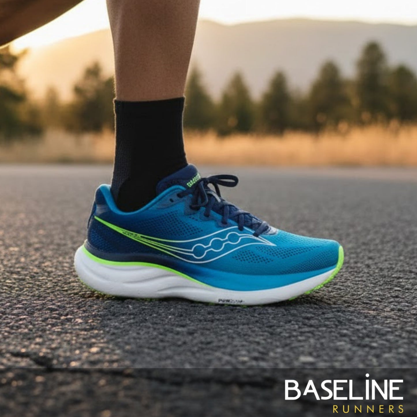 Blue Saucony running shoe on a road with 'Baseline Runners' branding